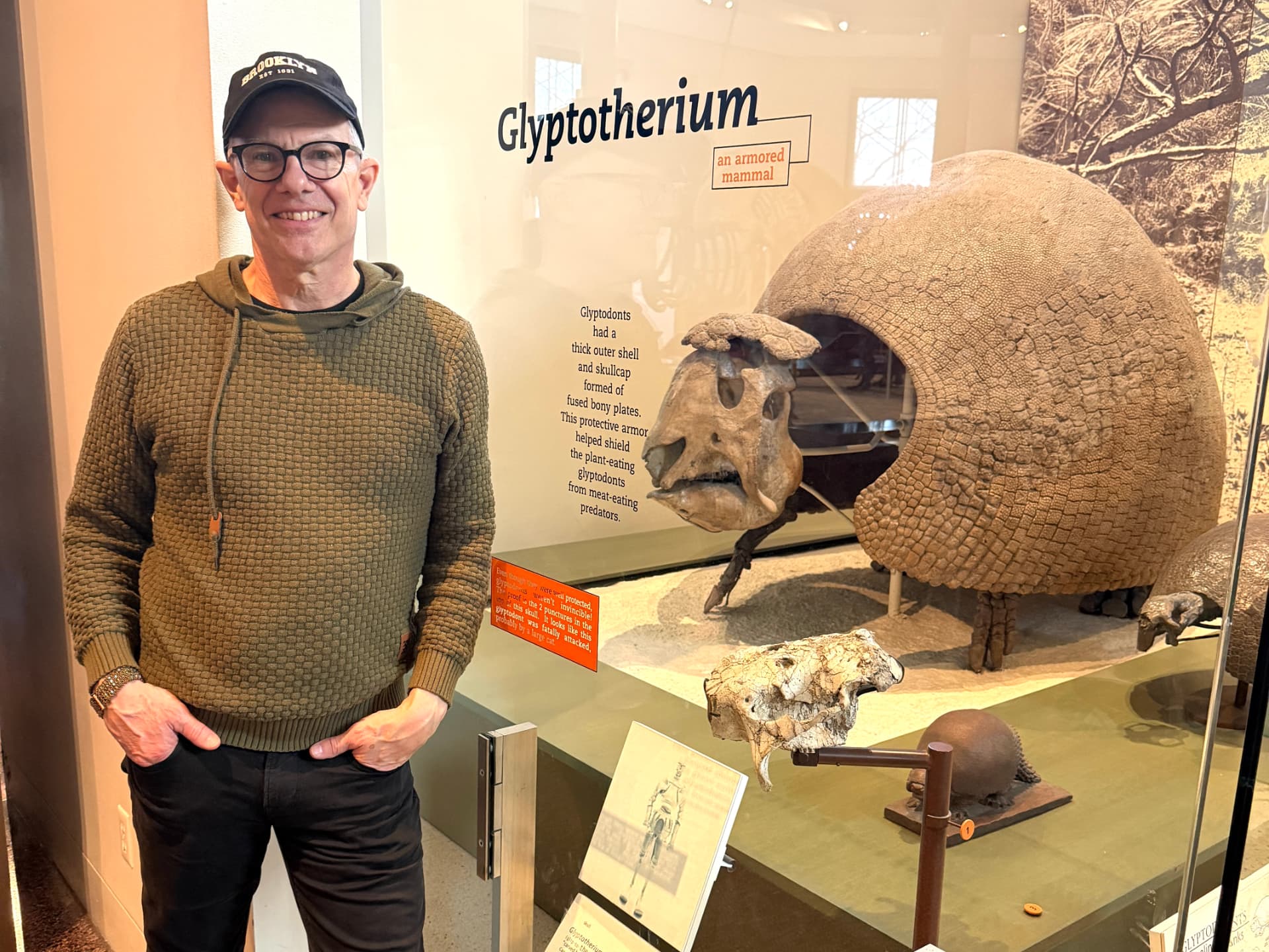 Co-founder Christopher Hoffmann beside a Glyptotherium fossil exhibit in a natural history museum